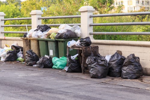Workers sorting items for recycling as part of a priced quote